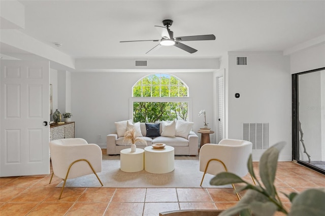 tiled living room with ceiling fan