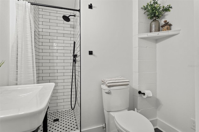 bathroom featuring walk in shower, sink, and toilet