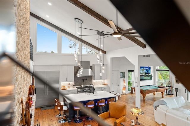 interior space featuring ceiling fan, high vaulted ceiling, billiards, light hardwood / wood-style flooring, and beamed ceiling