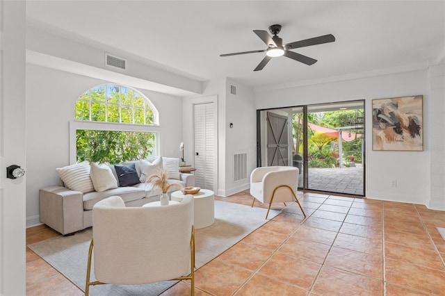 tiled living room featuring ceiling fan