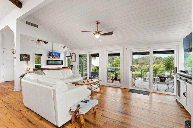 living room with ceiling fan, lofted ceiling with beams, wood ceiling, and light wood-type flooring