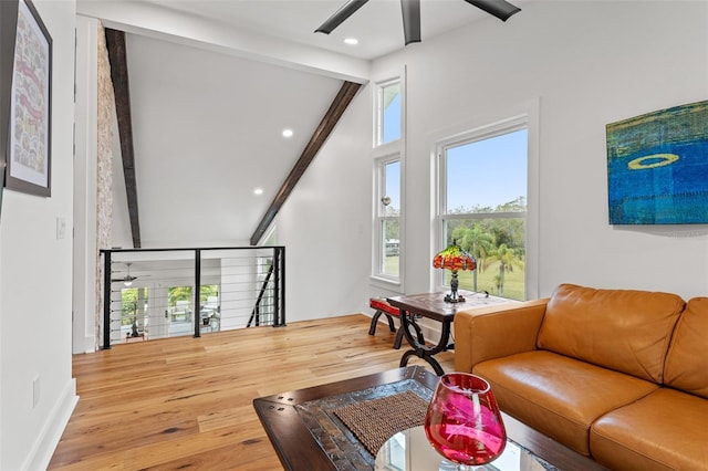 living room with lofted ceiling with beams, wood-type flooring, and ceiling fan