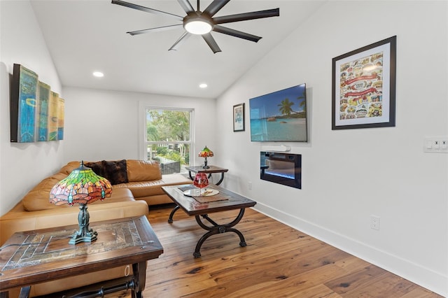 living room featuring lofted ceiling, wood-type flooring, and ceiling fan