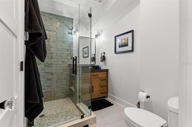 bathroom with tile patterned floors, walk in shower, toilet, and vanity