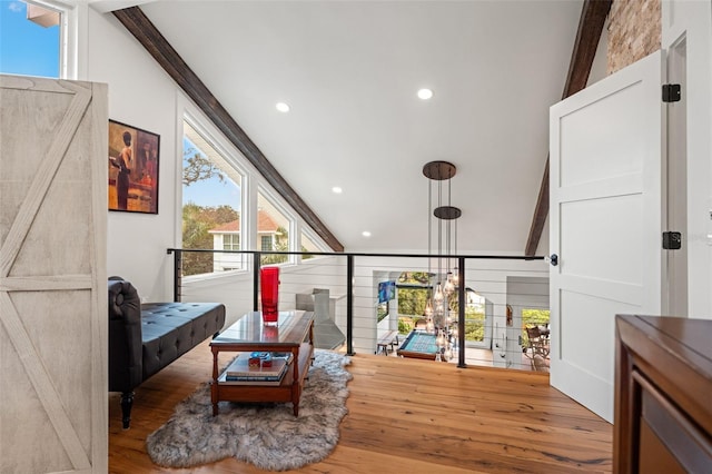 sitting room with hardwood / wood-style floors and lofted ceiling