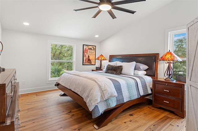 bedroom with ceiling fan, light hardwood / wood-style floors, and lofted ceiling