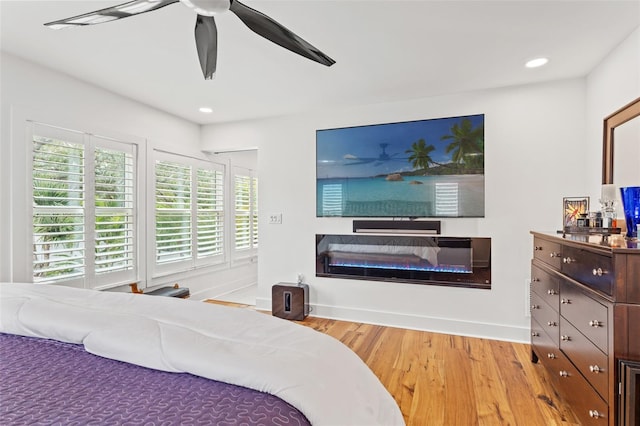 bedroom featuring ceiling fan and light hardwood / wood-style flooring