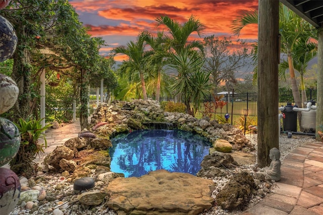 view of pool at dusk