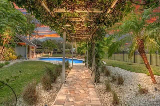 pool at dusk with a lawn