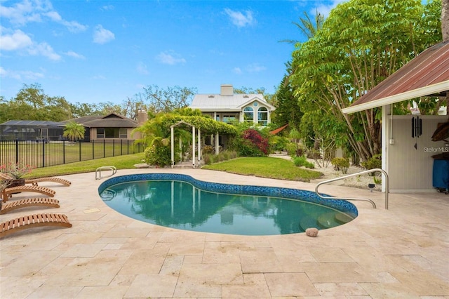 view of swimming pool with a patio area and a yard