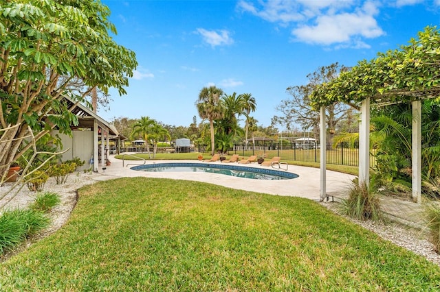 view of pool with a patio and a yard