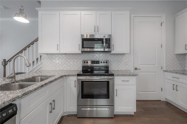 kitchen with sink, stainless steel appliances, white cabinetry, and tasteful backsplash