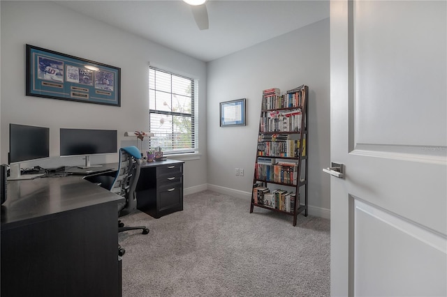 carpeted office space with ceiling fan