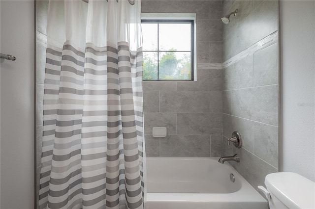 bathroom with shower / bathtub combination with curtain and toilet