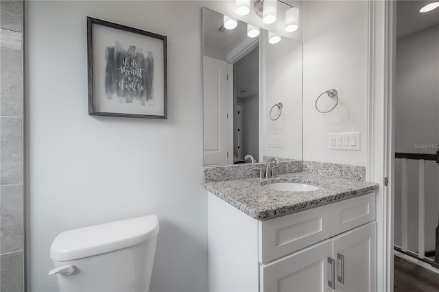 bathroom featuring toilet and vanity