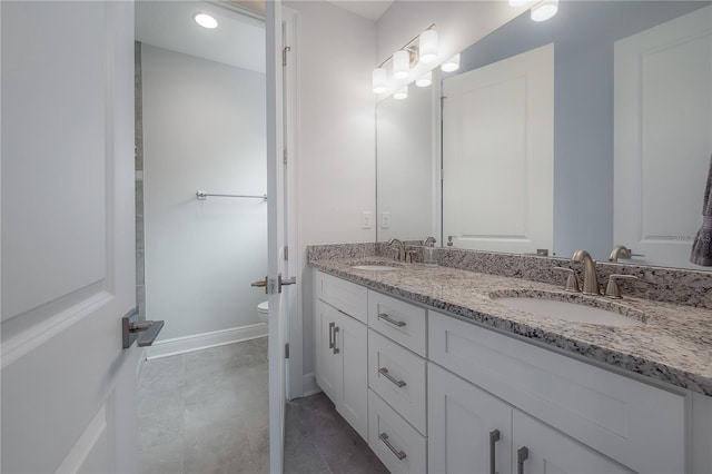 bathroom featuring tile patterned flooring, vanity, and toilet