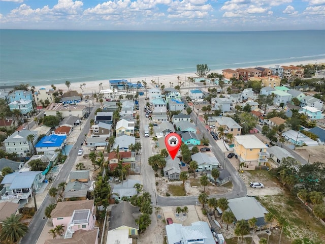 birds eye view of property featuring a water view and a view of the beach