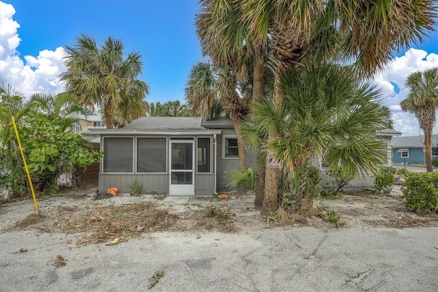 back of property with a sunroom