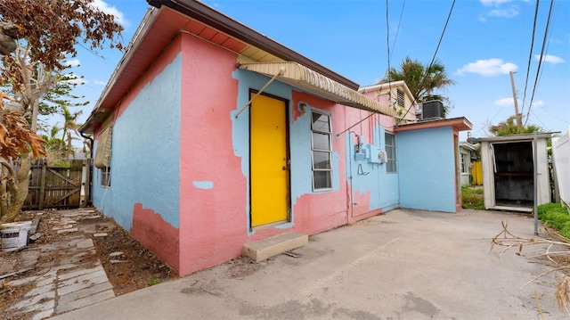 view of side of home featuring a patio and central AC