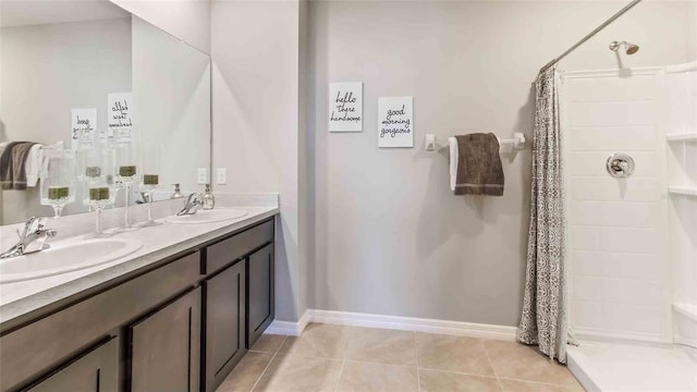 bathroom with tile patterned floors, walk in shower, and vanity