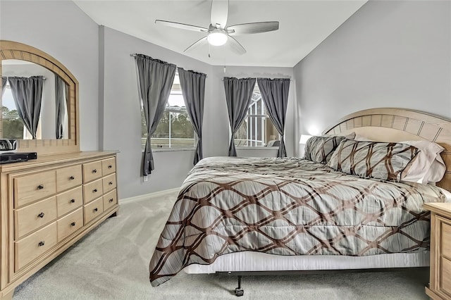 bedroom with lofted ceiling, ceiling fan, and light colored carpet