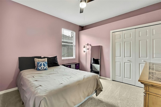 carpeted bedroom featuring a closet and ceiling fan