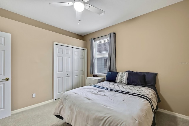 carpeted bedroom with ceiling fan and a closet