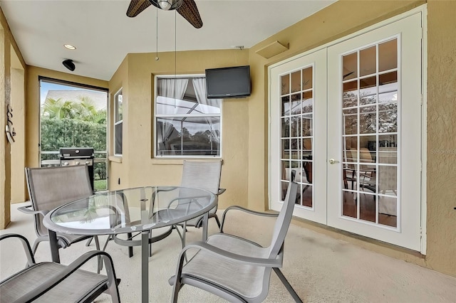 sunroom with ceiling fan and french doors