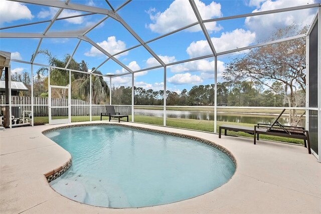 view of swimming pool with a lanai, a patio, and a water view