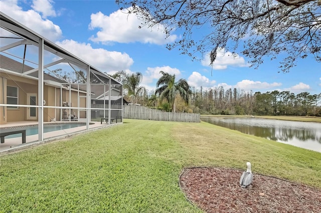 view of yard with a water view and glass enclosure