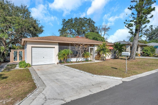 single story home with a front yard and a garage