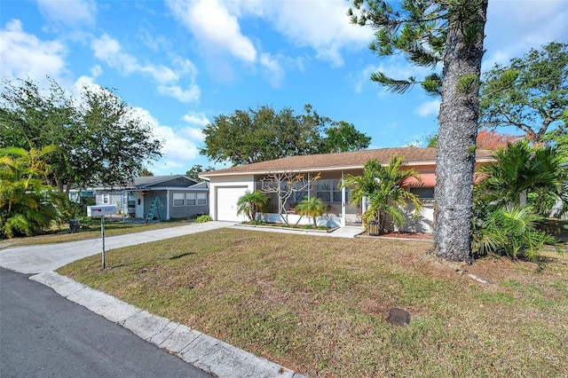 ranch-style house featuring a front lawn and a garage