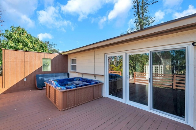 wooden deck with a hot tub