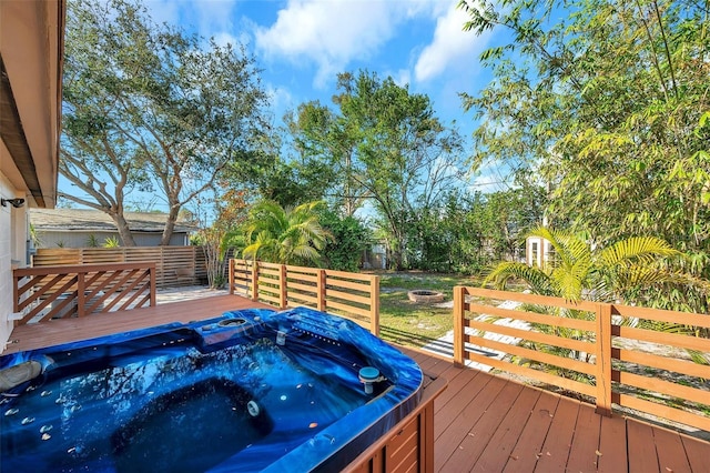 wooden deck featuring a hot tub