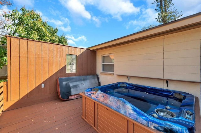 wooden deck featuring a hot tub