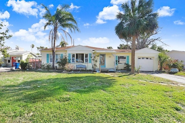 ranch-style house with a garage and a front lawn