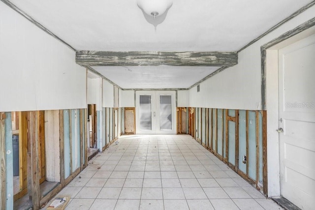 interior space featuring french doors and beamed ceiling