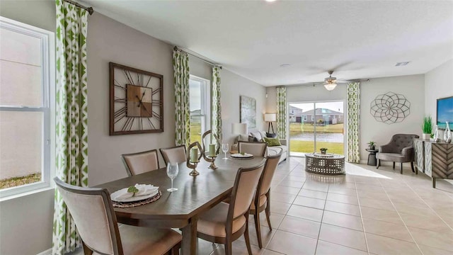 dining area featuring ceiling fan and light tile patterned floors