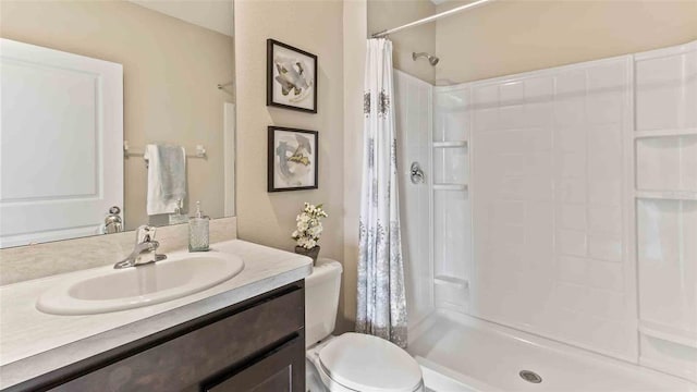 bathroom with toilet, curtained shower, and vanity