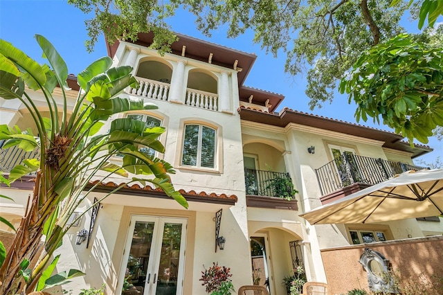 exterior space with a balcony and french doors