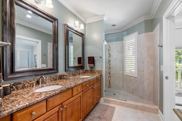 bathroom featuring a tile shower, tile patterned flooring, vanity, and crown molding