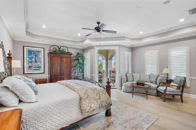 bedroom with access to exterior, ceiling fan, light hardwood / wood-style flooring, a tray ceiling, and crown molding