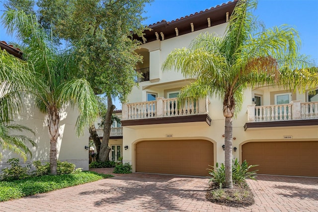 mediterranean / spanish-style home with a balcony and a garage