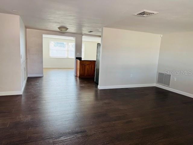 empty room with dark hardwood / wood-style floors