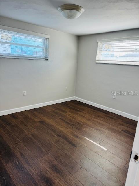 unfurnished room featuring dark hardwood / wood-style flooring