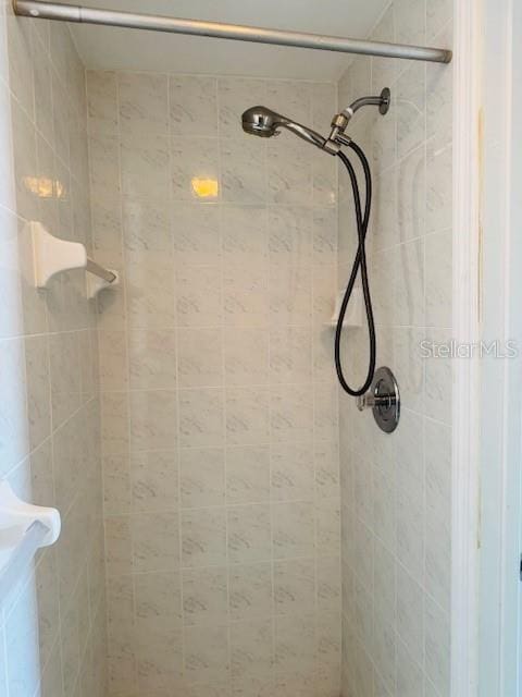 bathroom with a tile shower