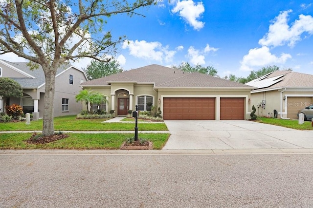 view of front of property with a front lawn and a garage