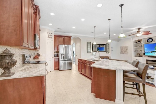 kitchen with stainless steel appliances, pendant lighting, crown molding, a breakfast bar, and sink