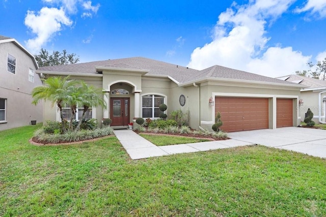 view of front facade with a garage and a front lawn