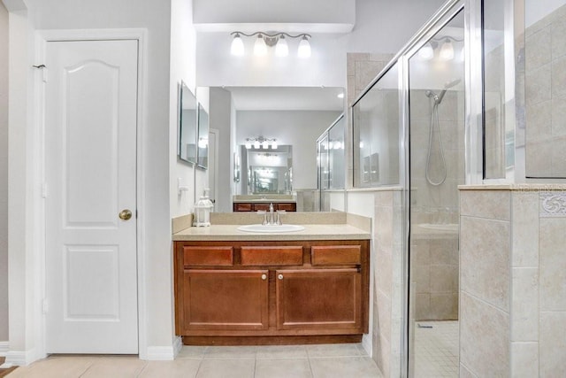 bathroom with vanity, tile patterned floors, and tiled shower